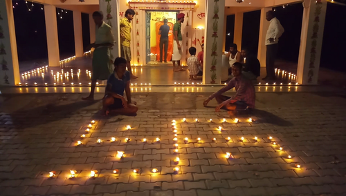 A swastika design made using Diyas inside a Hindu temple