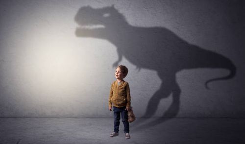 Dinosaurus shadow behind cute boy I’m dreaming about dinosaurus concept with cute little boy in an empty room kids dinosaurs stock pictures, royalty-free photos & images