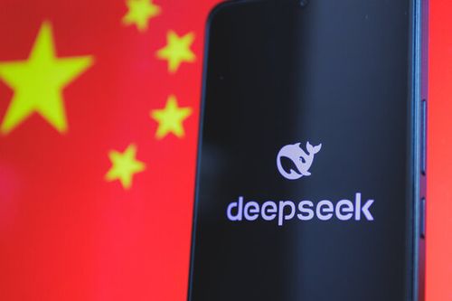 A smartphone displaying the Deepseek logo with the Chinese flag in the background. Growing Chinese technology and artificial intelligence on the global stage