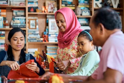 happy senior woman with family making wau bulan - making wau stock pictures, royalty-free photos & images