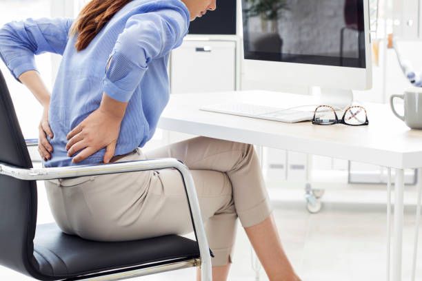 Businesswoman with pain in back Businesswoman with pain in back back pain stock pictures, royalty-free photos & images