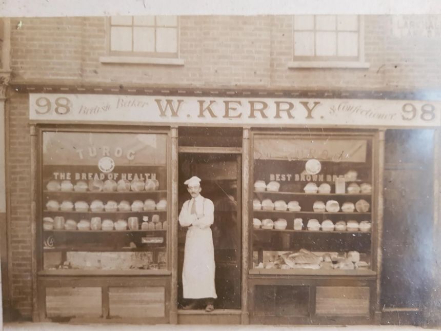 A 19th-century industrial bakery with workers preparing bread