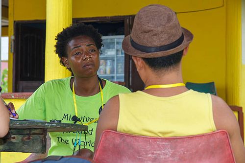 September 18th: The Midwife Alama Sylla is listening the Funder Matius Wau of the Love one Niha Pelita Kasih Foundation outside of the Lagundri Bay...