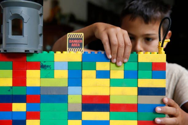 Year-old boy playing with Lego. Thailand.