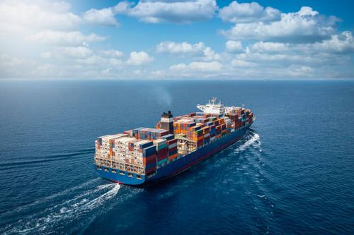 A large container cargo ship in motion A large container cargo ship travels over calm, blue ocean importing stock pictures, royalty-free photos & images