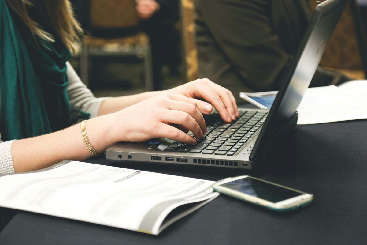 Woman Typing on Laptop · Free Stock Photo