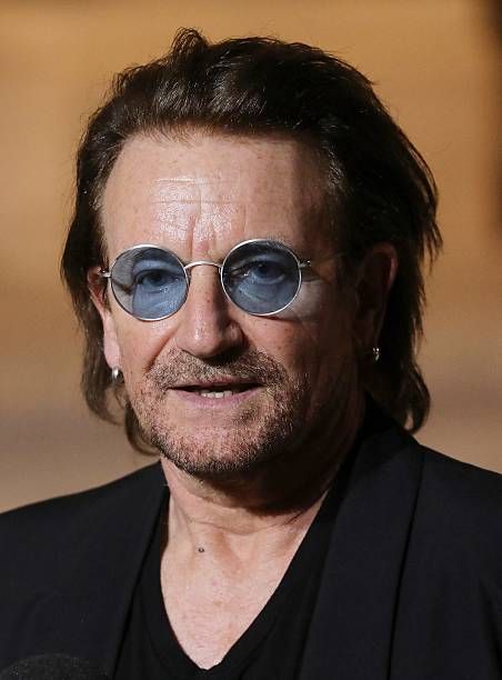 Irish lead singer of rock band U2, Paul David Hewson aka Bono delivers a statement in the courtyard of the Elysee Palace, in Paris, after a meeting...