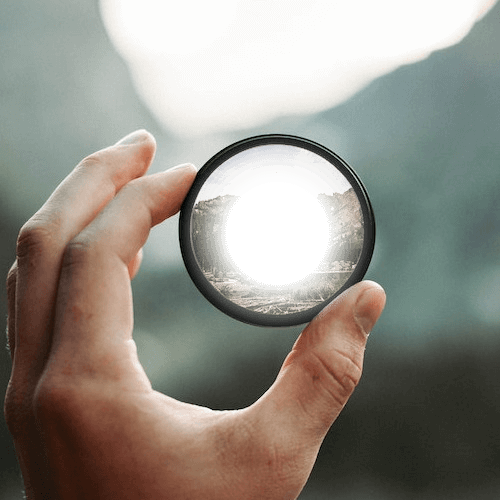 In this example, we create a radial gradient of transparency on a circular mirror image. We encompass the mirror with a square region in the input preview and set a radial gradient with a radius of 50, directed "Outside In". At the very center of the mirror, the transparency is set to 100%, while there is no transparency at the mirror's edge. (Source: Pexels.)