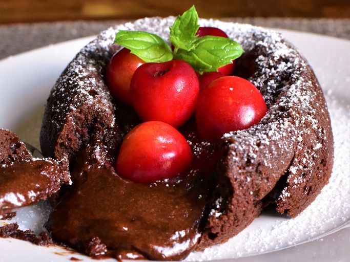 lava cake garnished with cherries and basil