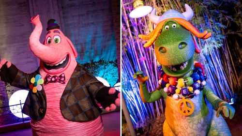 Two Disney Jollywood Nights stars: Bing Bong the pink elephant and Partysaurus Rex the green dinosaur, both in festive beads.