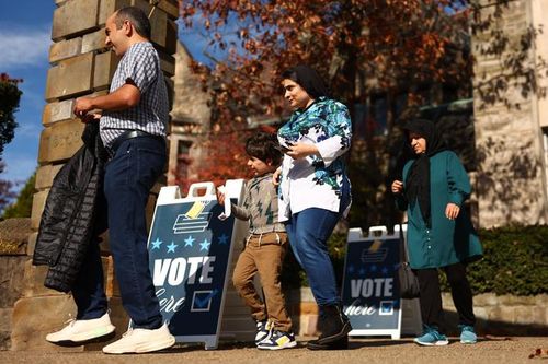 Voters walk past “Vote Here” signs in Pittsburgh’s Squirrel Hill neighborhood on Nov. 5, 2024.
