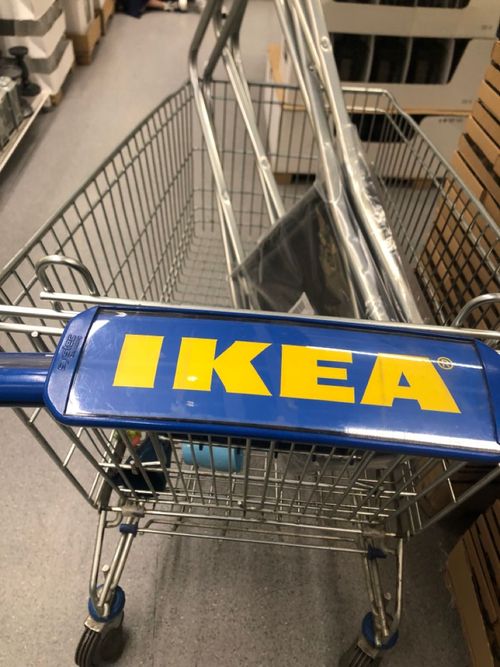 a blue ikea shopping cart with the word ikea on it's side