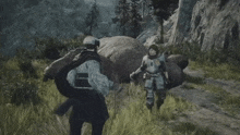 two soldiers are walking in a field with a large rock in the background .