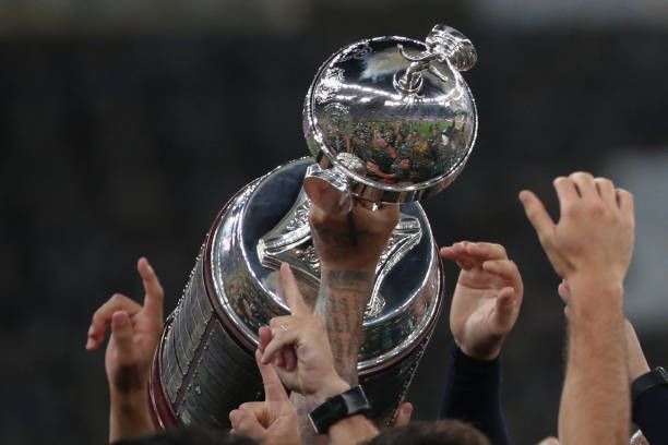 Players of Palmeiras celebrate with the trophy after winning the Copa Libertadores football tournament by defeating Santos 1-0 in the all-Brazilian...