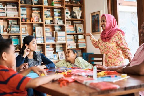 family having fun while making wau bulan at home - making wau stock pictures, royalty-free photos & images