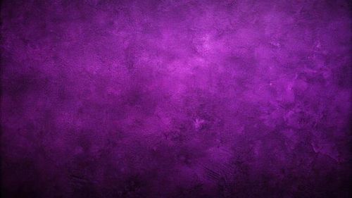 abstract dark grainy background in purple colors photo