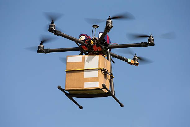 Drone carrying parcel Drone carrying parcel drone delivery stock pictures, royalty-free photos & images