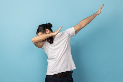 Portrait of anonymous unknown man with beard wearing white T-shirt standing in dab dance pose, internet meme, celebrating success. Indoor studio shot isolated on blue background. Meme pose stock images, royalty-free photos and pictures