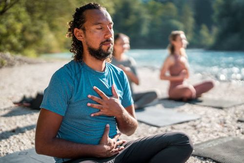 male meditating in yoga session outdoors - diverse people meditating stock pictures, royalty-free photos & images