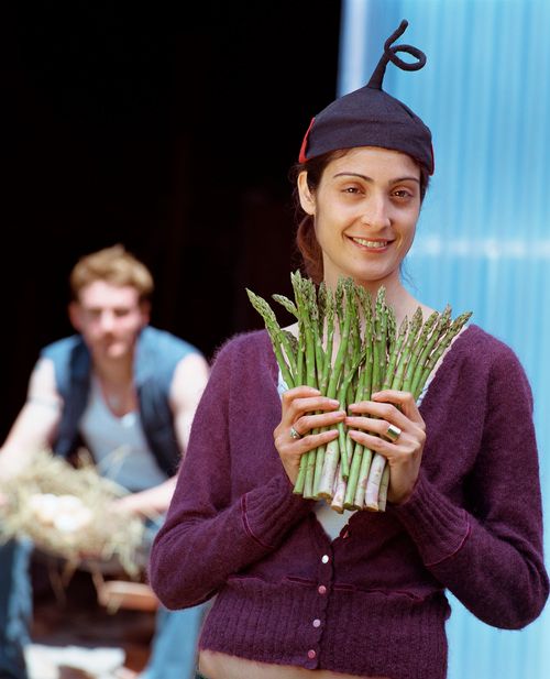 Woman holding asparagus on a farm FREE Stock Photo, woman,  asparagus,  farming picture