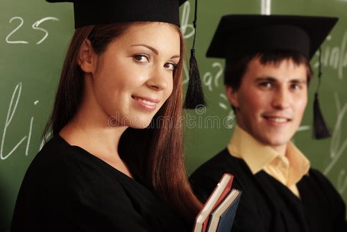 Educational theme: graduating students in academic gown in a classroom. Bachelors degree stock images, royalty-free photos and pictures