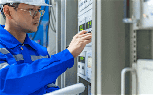 A picture of a worker operating embedded computers in a factory