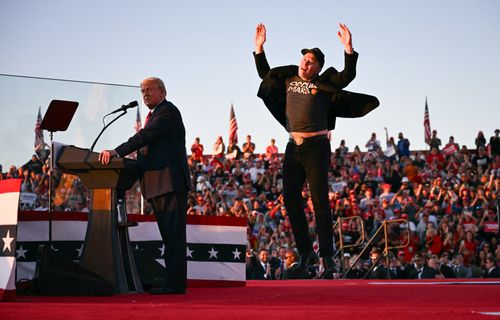 Tesla CEO Elon Musk jumps on stage as he joins Donald Trump during a campaign rally at site of his first assassination attempt in Butler, Pennsylvania on October 5.