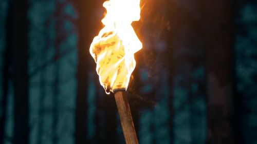 Handmade torch - piece of cloth burning on the stick - waving with the torch
