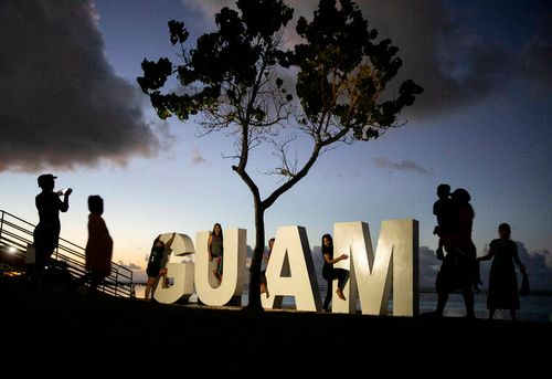 ASSOCIATED PRESS
                                Tourists pose for photos at a sign along a popular beach in Tamuning, Guam, on May 11, 2019.
