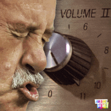 a man with a mustache is looking at a volume knob