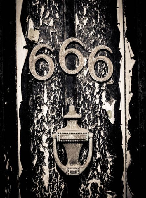 Scary 666 Door A Scary Door With The Number 666 And Black Peeling Paint For Halloween number 666 stock pictures, royalty-free photos & images