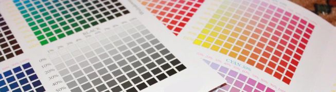 Printouts of test sheets for color profile adjustments. Numerous small squares with corresponding colors and color values allow comparison of how the color appears on paper with the applied color profile.