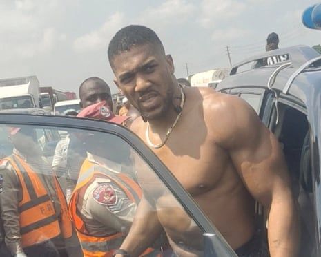 Bare-chested Anthony Joshua gets into a car
