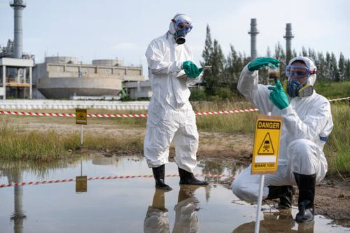 environmental researcher taking water sample from toxic on oil spill mixed with water. - environmental hazards stock pictures, royalty-free photos & images