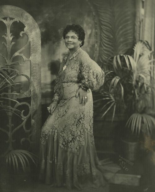 1936 this dress is a peach color, popular for evening wear in the mid 1930s