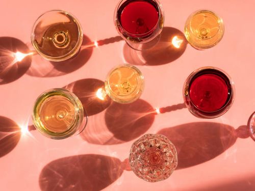 wine glasses on a pink background in the sunlight - wine colour stock pictures, royalty-free photos & images