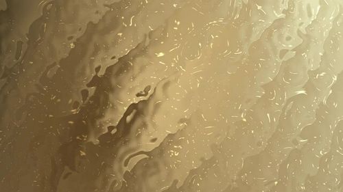 Gold gradient illustrator abstract marbled texture in elegant shimmering gold tones.