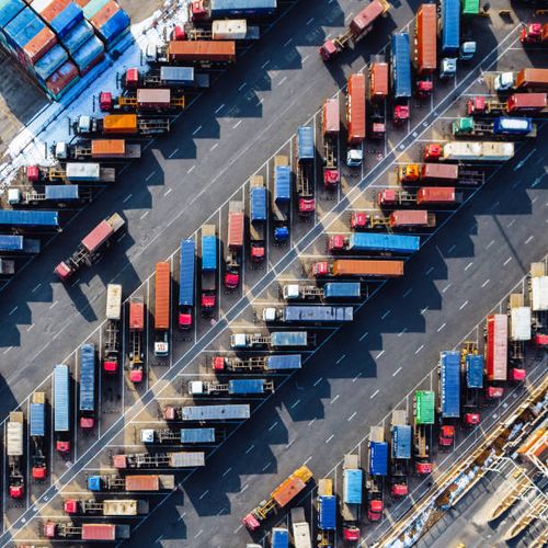 aerial view, rows of trucks driving in harbor with trailers - import stock pictures, royalty-free photos & images