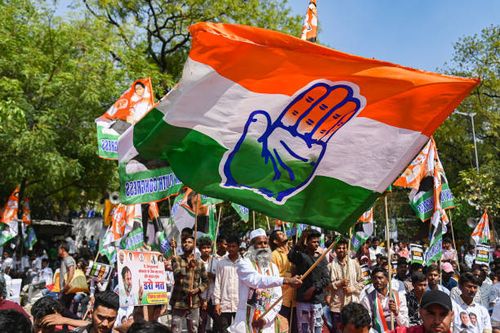 Supporter of Indian National Congress waves a flag during a protest against the disqualification from the Indian Parliament of India's main...