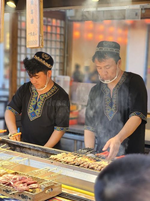 Uyghur vendor preparing lamb skewers