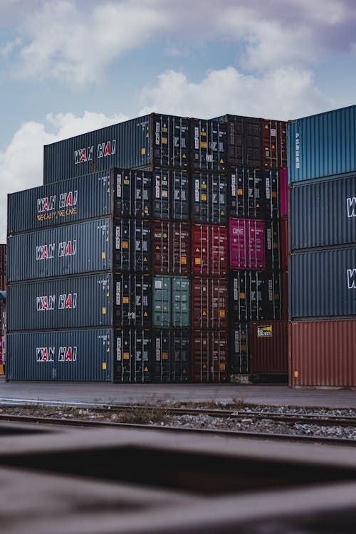Free High vertical stack of cargo containers at a port, symbolizing global logistics. Stock Photo