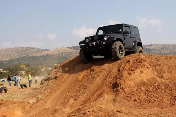 Jeep Cherokee driving off-road over dirt terrain demonstrating 4x4 capability near Southern California trails