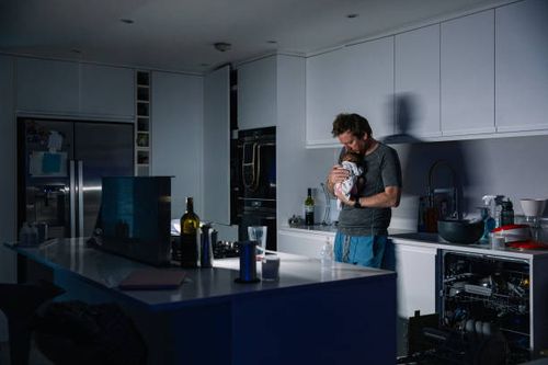 mature man trying to get his newborn baby to sleep late at night - night kitchen stock pictures, royalty-free photos & images