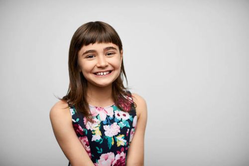 smiling girl against gray background - girl poses stock pictures, royalty-free photos & images