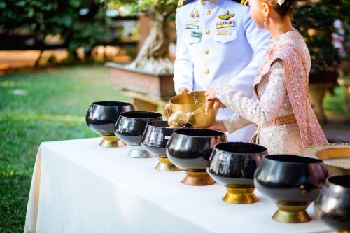 A man and woman wearing Thai traditional outfits