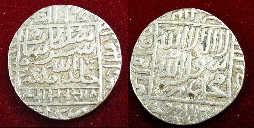 Silver coins with raised writing
