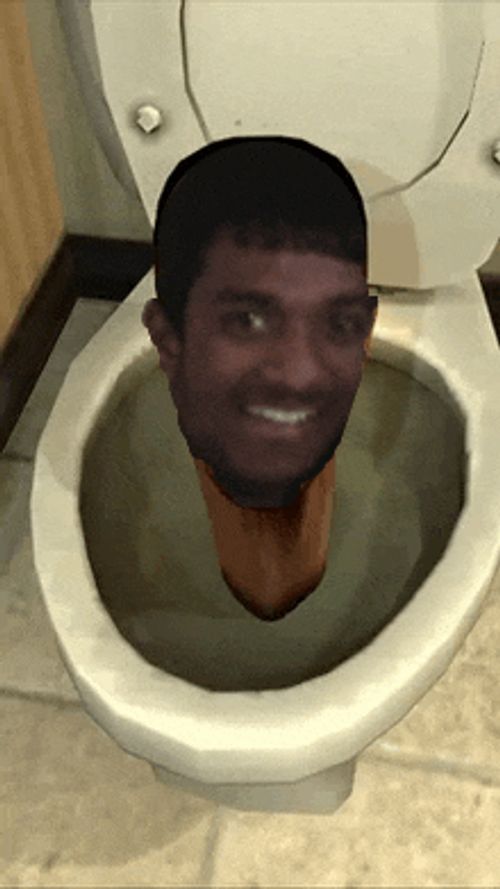 a man 's head is visible in a toilet bowl