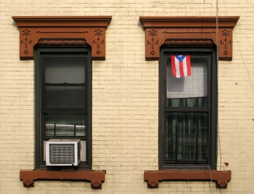 flag of puerto rico hanging from sash window of house in brooklyn, new york city - retro home exterior stock pictures, royalty-free photos & images