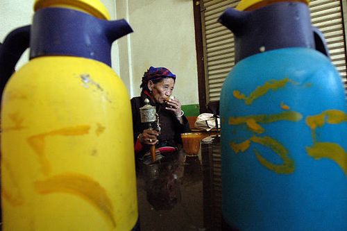 Tibetan pilgrim drinking butter tea in Lhasa
