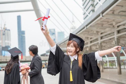 Woman graduate bachelor`s degree holding diploma with couple congratulation background. Bachelor s degree stock images, royalty-free photos and pictures